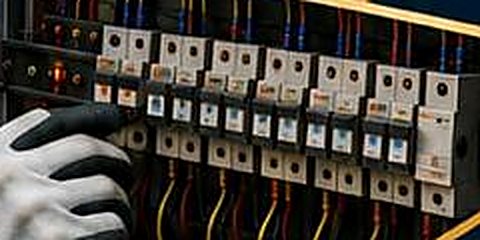 Engineer working on a distribution board with circuit breakers